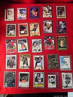 Full layout of 25 Wayne Gretzky cards in plastic holders on red background