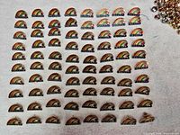 Grid of 80 rainbow Canadian location pins