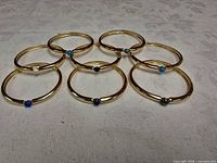 All eight gold-tone bangles laid out