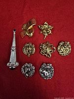 Group shot of all eight brooches on red background