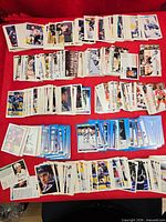 Wide view of all stacks of hockey cards laid out on red surface