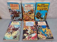 Front covers of all six Terry Pratchett Discworld paperbacks