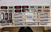 Tabletop view of all Fossil watch tins laid out in rows