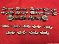 All chopstick rests laid out on red cloth showing quantity and two styles