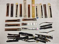 Overview of all packaged and loose watch bands on table
