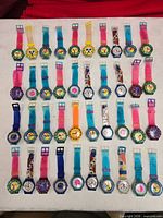 Front view of 40 colourful Gitano quartz watches laid in five rows