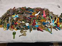 Pile of several hundred colorful uncut key blanks on cloth