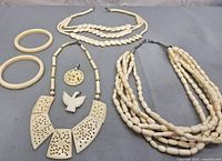 Full lot showing all seven ivory-tone jewelry pieces