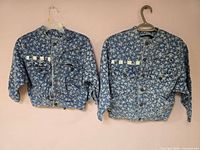 Both jackets front view on hangers