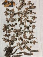 overview of all charms, chains, wood pieces on cloth