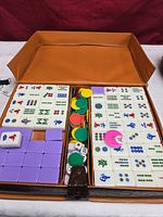 Open case showing full tile set, chips and dice