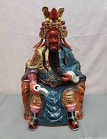 Front view of glazed porcelain Guan Yu figure on throne