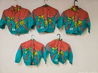 Five jackets hung showing front design