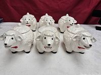 Six ceramic sheep canisters front view