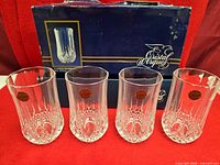 Four crystal Longchamp tumblers lined in front of original box