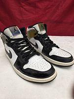 three-quarter view of both sneakers showing overall condition and color-changing collar