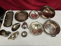 Group shot of all nine silver-plated hollowware pieces