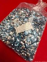 Full sealed bag filled with blue faceted oval beads