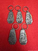 Five pewter keychains front view showing Toronto skyline design and CN Tower