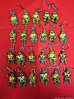 Group shot of all keychains laid out on red background