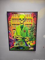 Full view of framed “What’s Your Pleasure” blacklight poster