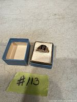Ring set in its box showing design and stone