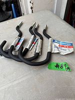 Four Mastercraft bicycle hooks on table