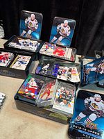 Five open Upper Deck hockey tins filled with cards