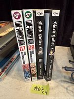 Spines of four manga volumes: One-Punch Man 7, One-Punch Man 8, Black Butler 3, Black Butler 1