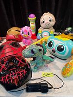 Group shot showing majority of toys including masks, plush, electronic figures