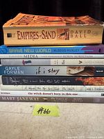 Stack of six paperback books showing titles and authors