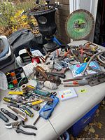 Overview of table with assorted tools and hardware