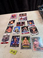 Overview of 14 WWE trading cards laid out on table