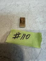 Ingot next to reference tag showing scale