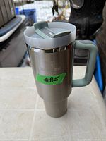 Front view of Stanley stainless steel The Quencher tumbler with handle and lid
