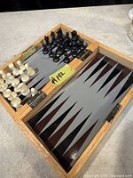 Open board showing interior backgammon surface and chess pieces in compartments