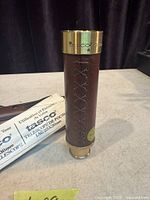 Telescope collapsed showing leather wrap and brass ends