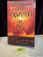 Front cover of Monsters Of Men paperback showing title, author, series info