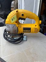 Side view of Dewalt corded jig saw showing body, base, and cord