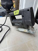 Left side view of Black & Decker jig saw showing body, handle, base and cord