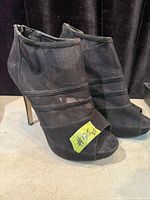 Pair of black stiletto booties front view
