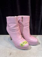 Left and right boots side view showing texture, heel and zipper