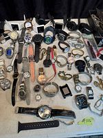 Top view of entire grouping of watches and parts spread on table