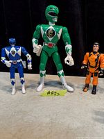 Front view of three action figures: Green Ranger, Blue Ranger, James Bond