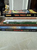 Stack of eight assorted paperback books