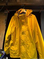 Front view of yellow hooded winter jacket hanging
