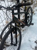 Full side front view of Nakamura bicycle against fence in snow