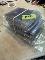 Stack of sealed packs of clear resealable bags bound with an elastic