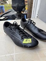 Top view of both sneakers showing uppers, laces, size tag label on toe