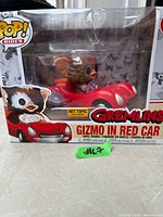 Front view of boxed Funko Pop! Rides Gizmo in Red Car showing Hot Topic exclusive sticker and packaging